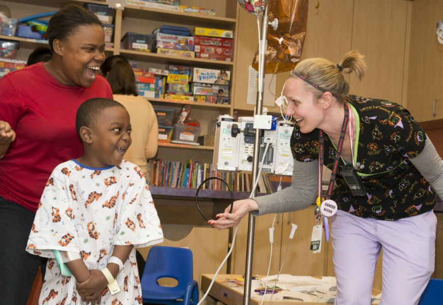 mother, child and nurse laughing