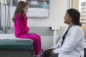 doctor with child girl on table